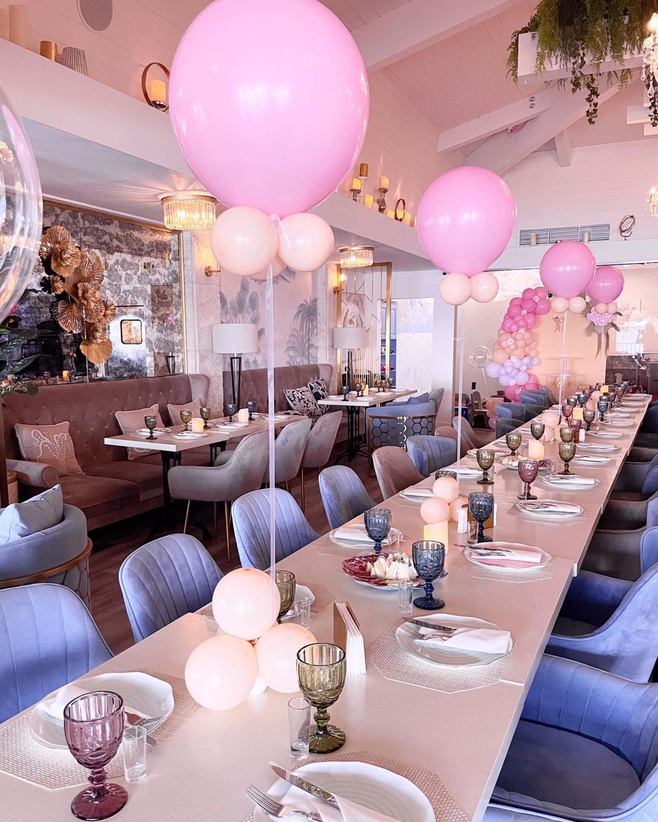 Restaurant long table styled with jumbo balloon centerpieces